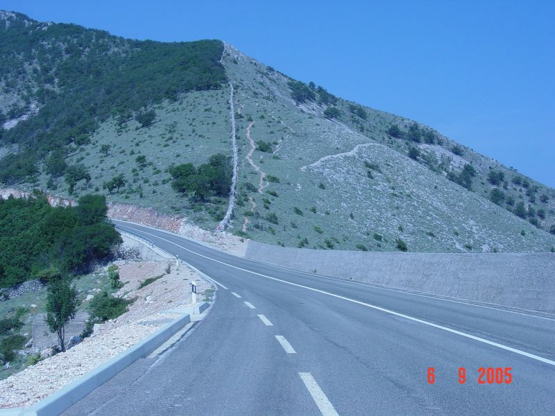 Rocks to the left, rocks to the right, and a rock wall climbing the mountain.